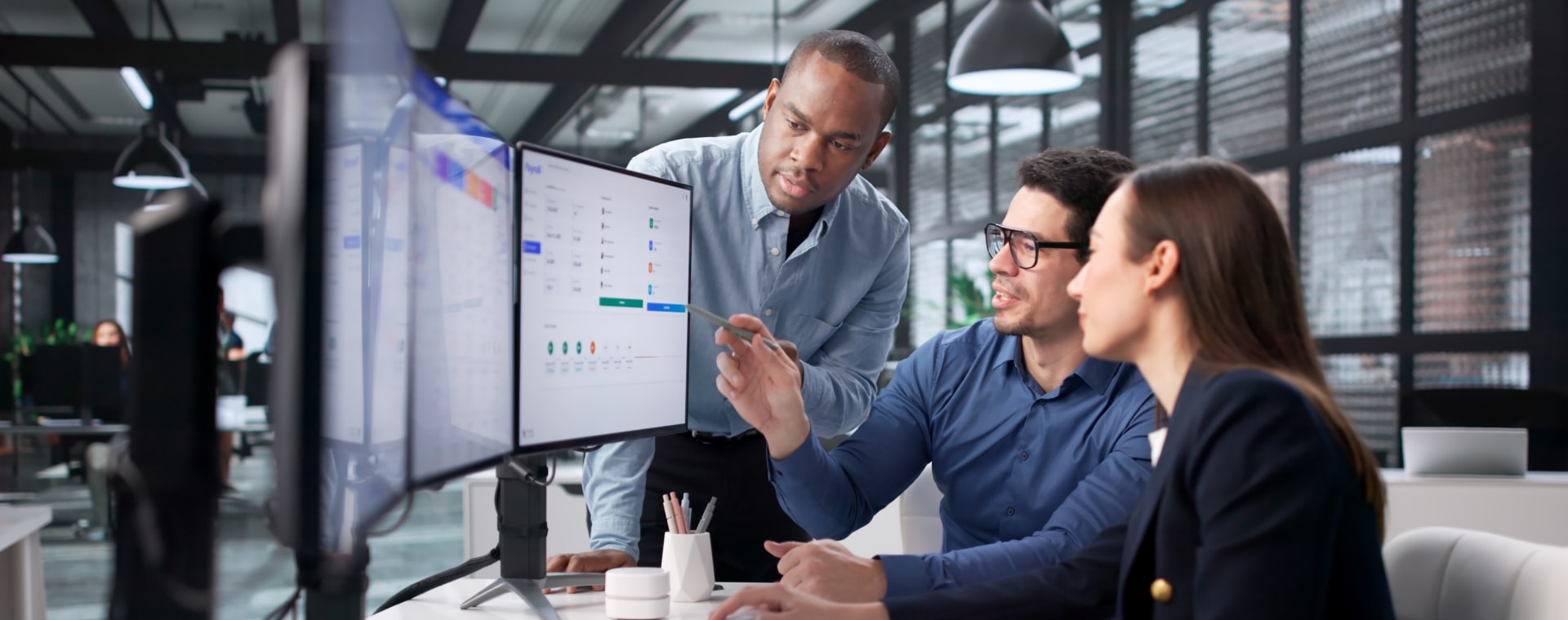 Team reviewing property data on a monitor